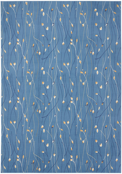 Blue area rug with wispy white, navy & gold stems & tiny gold leaves in a botanical, contemporary pattern.