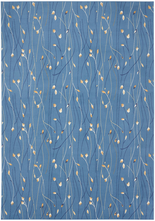 Blue area rug with wispy white, navy & gold stems & tiny gold leaves in a botanical, contemporary pattern.