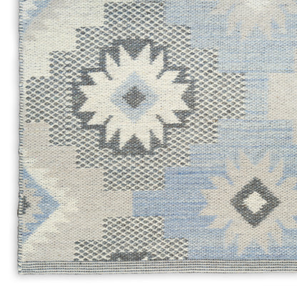 Blue, white & gray woven rug with geometric starburst and diamond motifs; kilim-style textile.