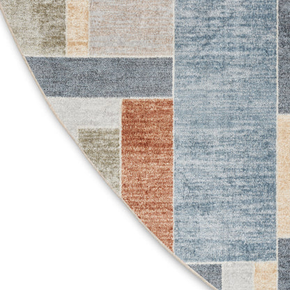 Round patchwork area rug with blue, beige, tan and orange blocks in a distressed contemporary design.