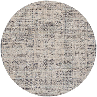 Round woven area rug with distressed beige and navy geometric patchwork.
