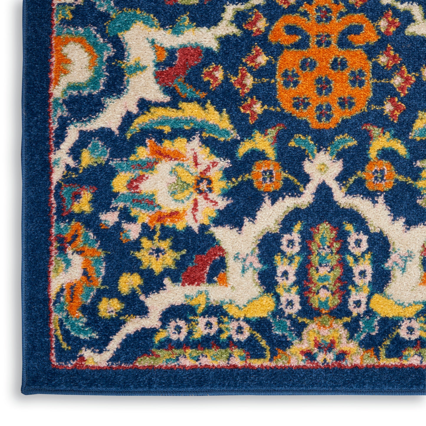 Close-up of a blue wool rug corner with vibrant multicolor floral motifs and a dark blue border.