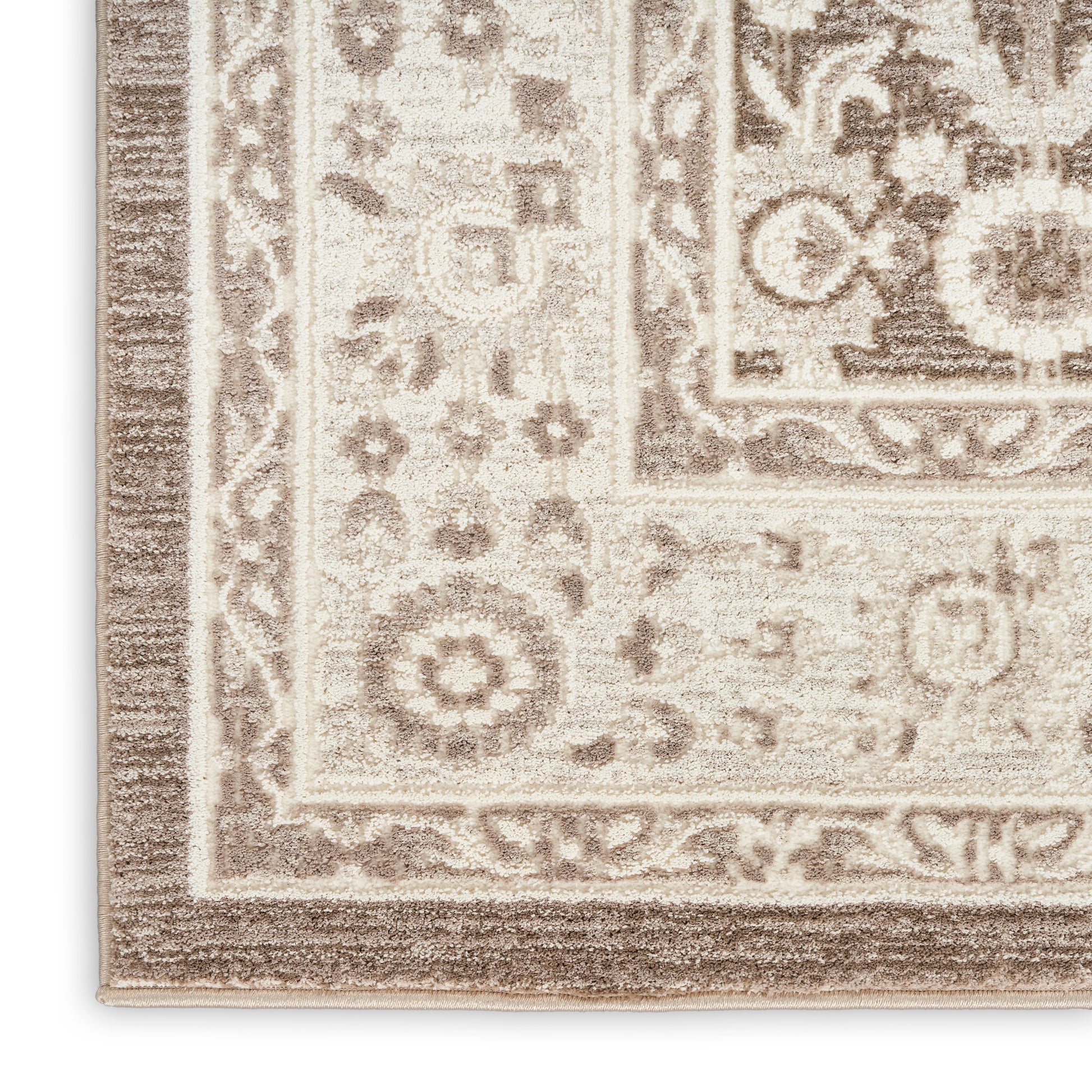 Beige cream oriental rug corner with intricate brown floral border and medallion pattern; soft woven texture.