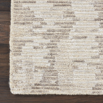 Beige textured rug with cream and taupe horizontal stripes on dark wood floor.