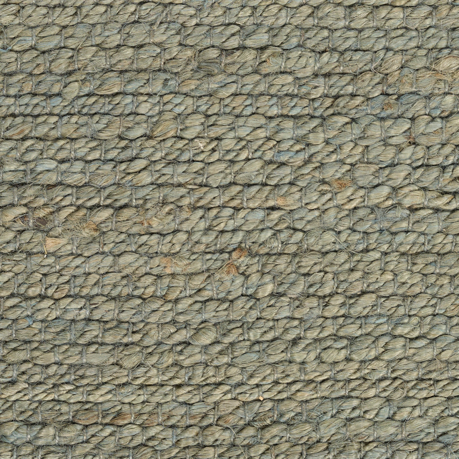 Close-up of natural jute rope-weave rug in beige-gray; rustic rug texture.