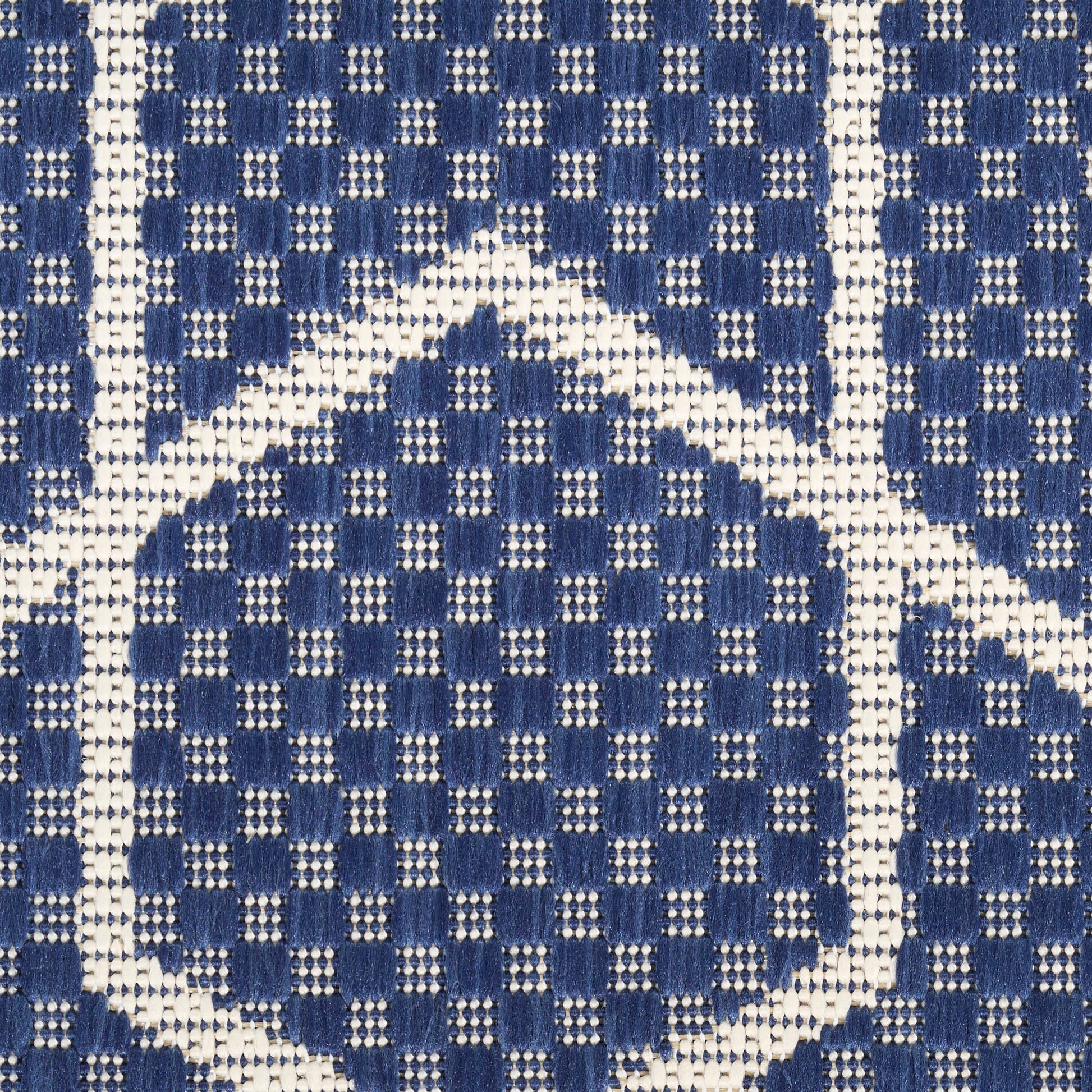 Blue and white woven rug featuring a repeating diamond grid pattern with small square motifs.