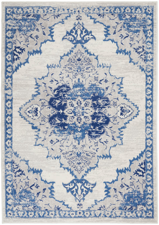 Blue and cream oriental rug with a large central floral medallion and ornate border.