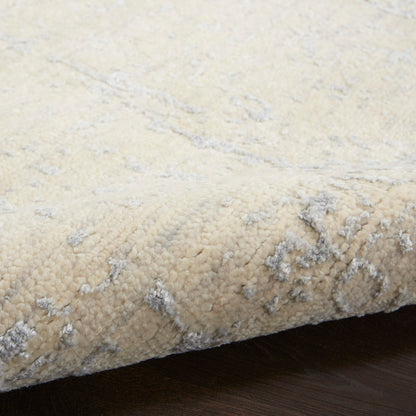 Cream beige rug with subtle gray marbled pattern and plush high-pile texture.