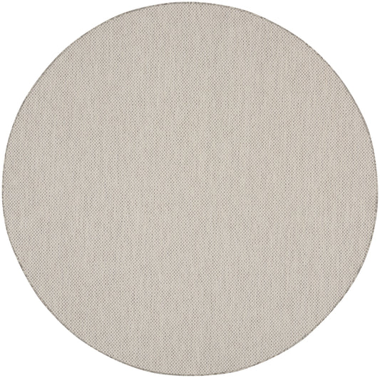 Beige round fabric disc with dotted mesh texture; minimalist round décor accessory.
