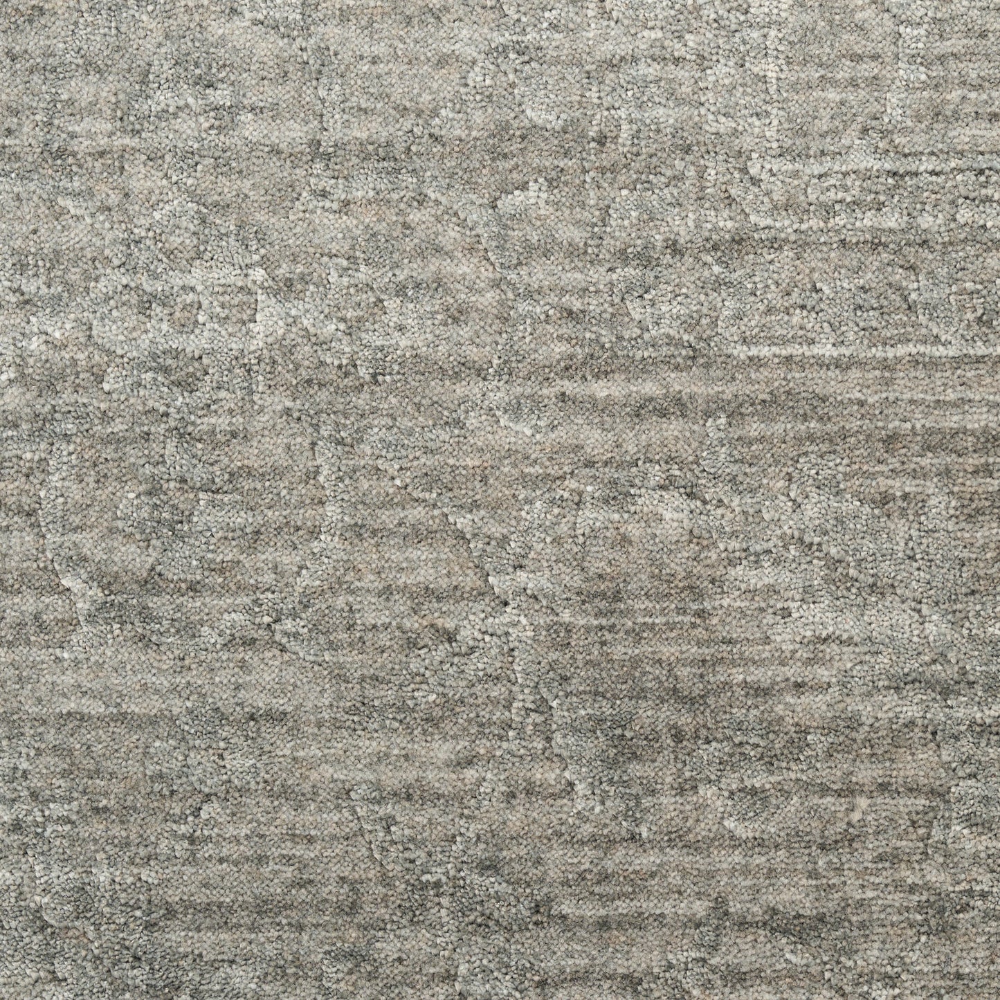 Gray textured rug with muted distressed pattern and soft, dense loop pile for a neutral living space.