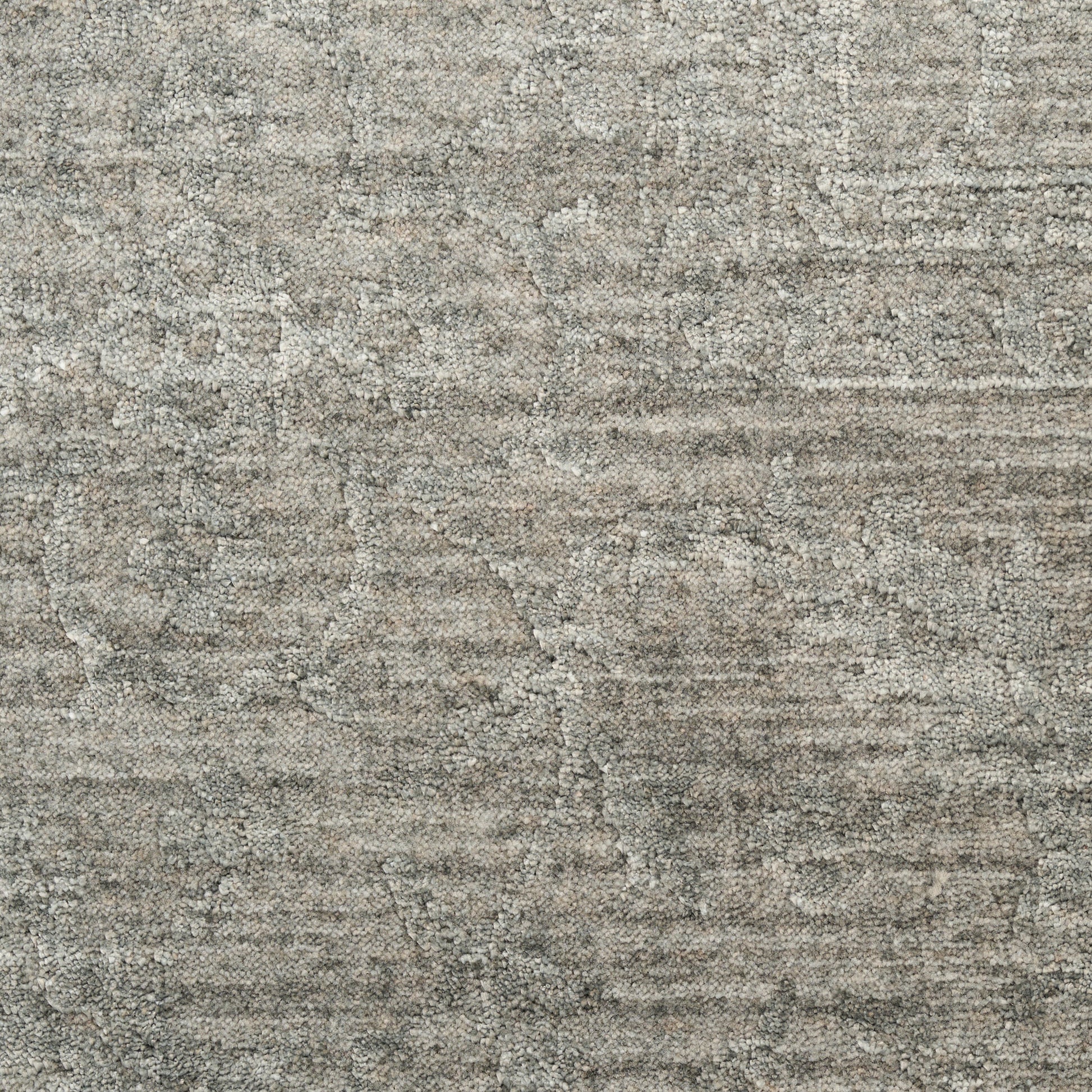 Gray textured rug with muted distressed pattern and soft, dense loop pile for a neutral living space.