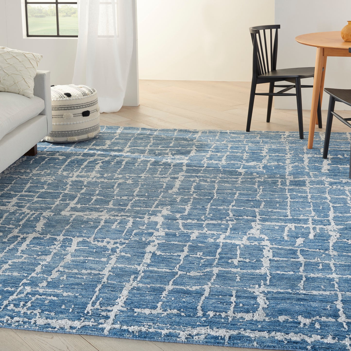 Blue and white geometric area rug with lattice pattern, woven texture for modern living room.