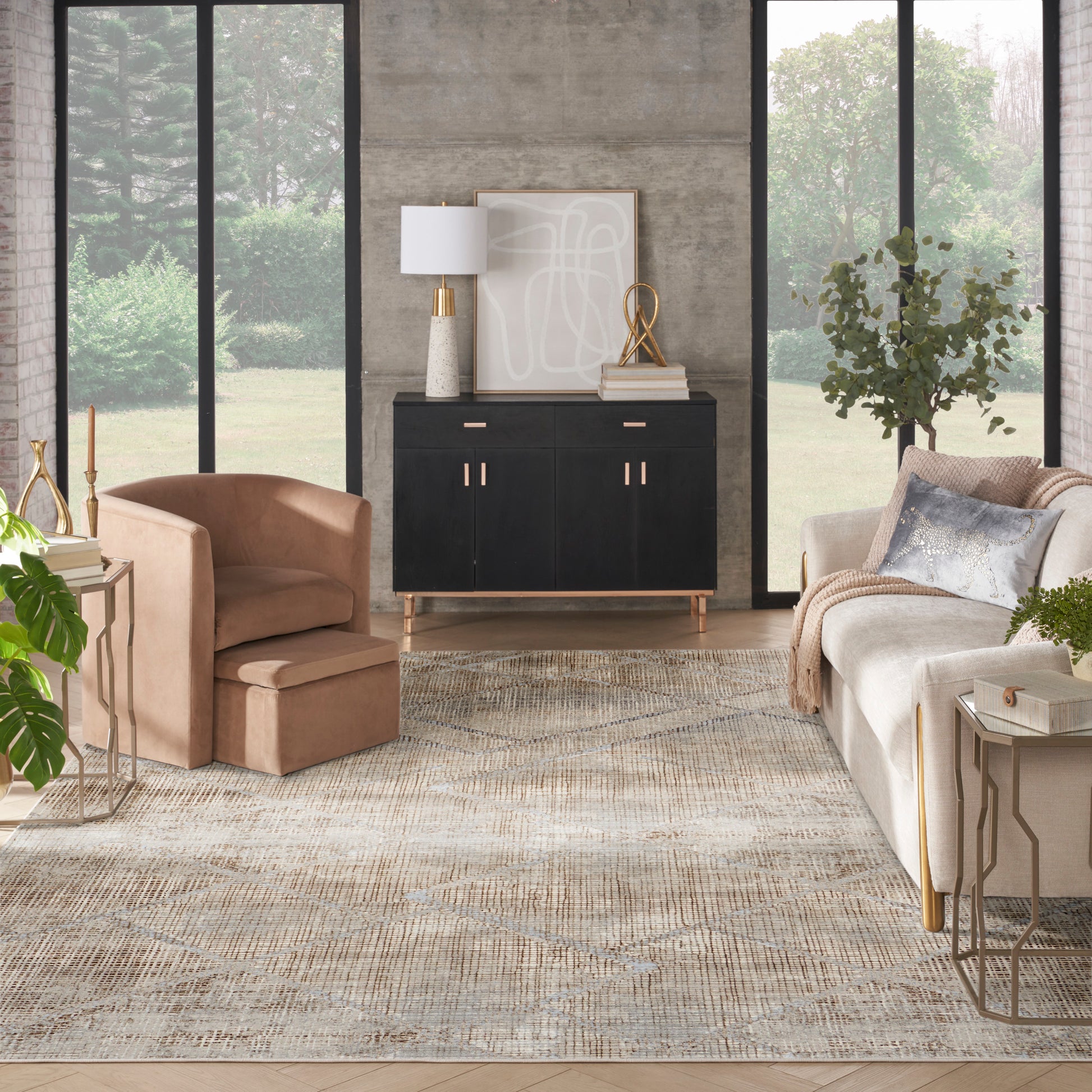 Modern living room with black cabinet, tan leather chair, beige sofa, abstract art, gold accents, and a textured beige rug.
