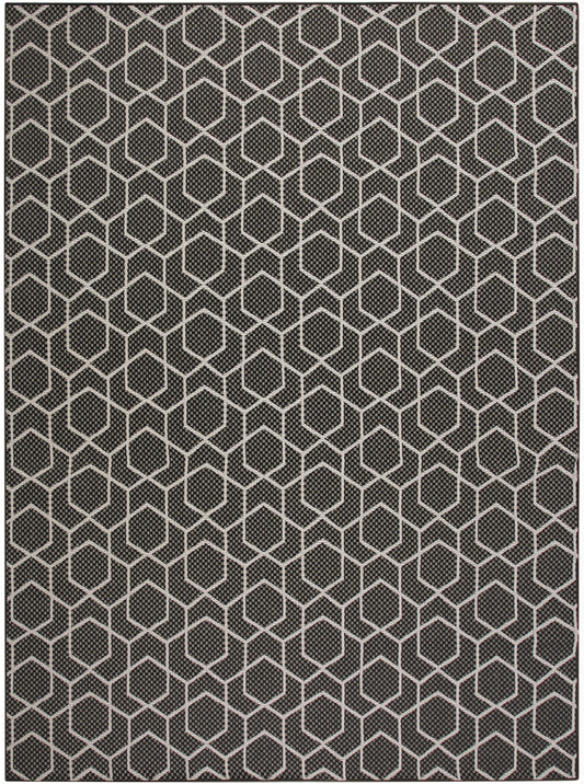 Dark gray rug with a white hexagon honeycomb pattern and woven texture; modern geometric floor decor.