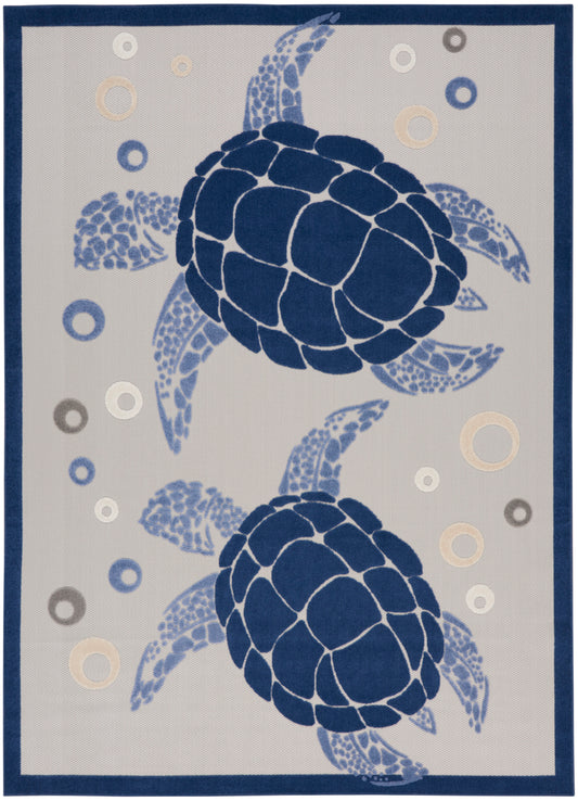 Rectangular rug with two dark blue sea turtles on beige background, mosaic shell pattern, circular bubbles, navy border.