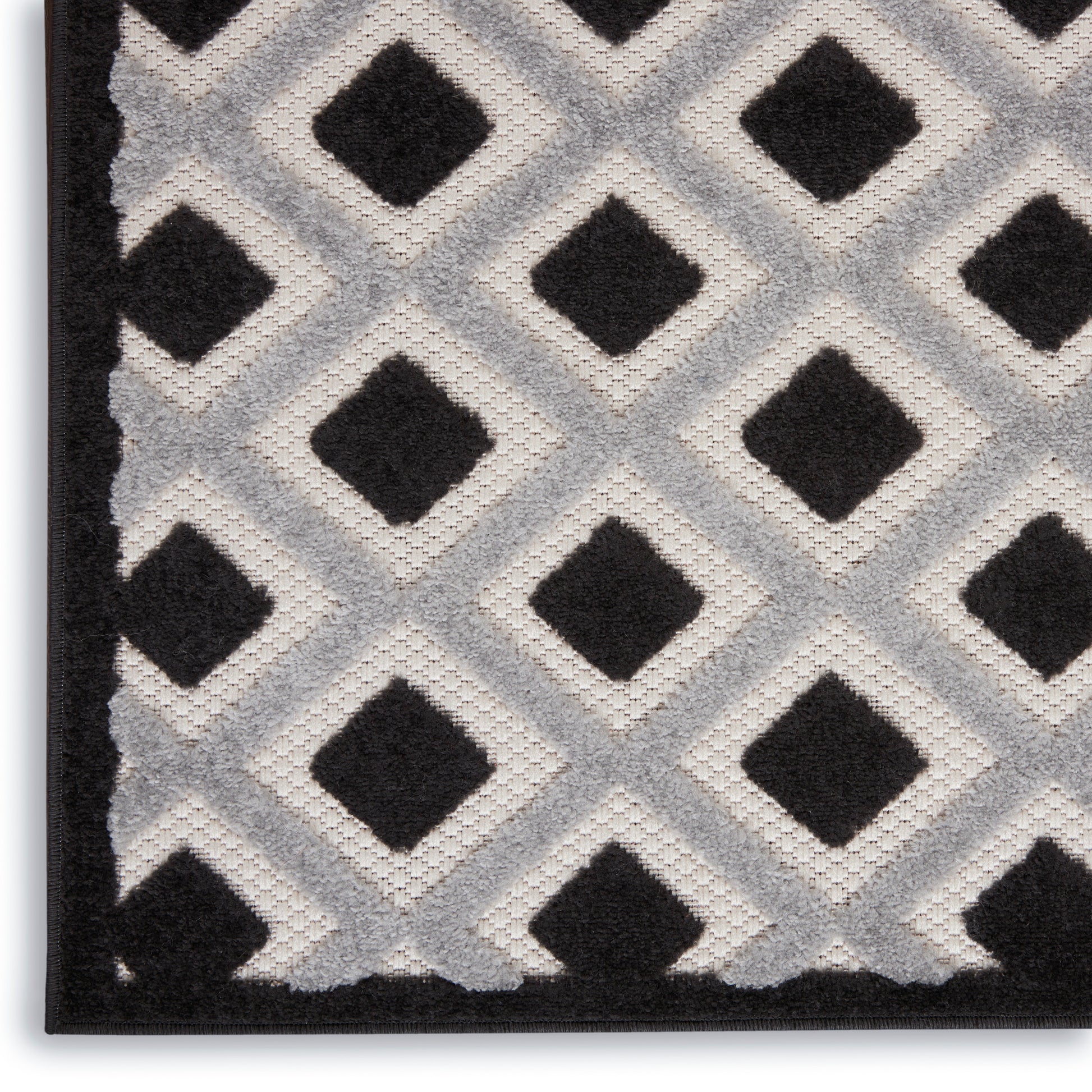 Gray shag rug with black diamond lattice pattern and dark border edge.
