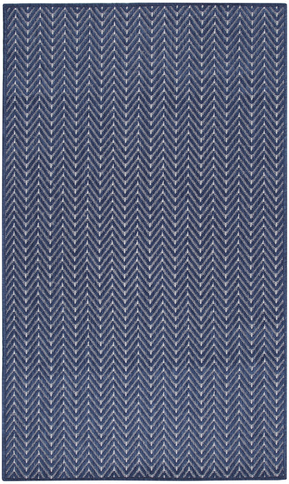 Navy blue rug with white chevron zigzag pattern; woven textile, rectangular.