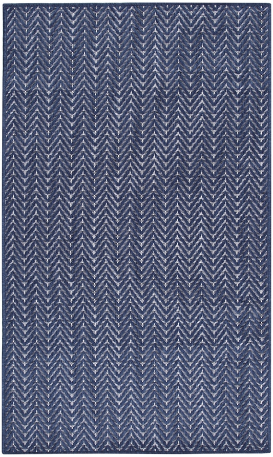 Navy blue rug with white chevron zigzag pattern; woven textile, rectangular.