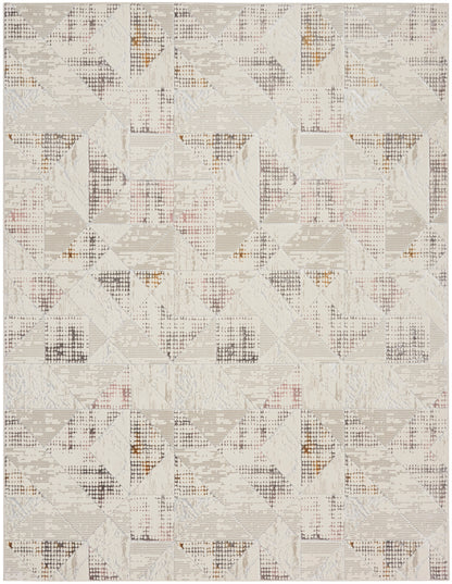 Neutral geometric rug with patchwork triangles in ivory, beige, and light gray, with subtle rust accents.