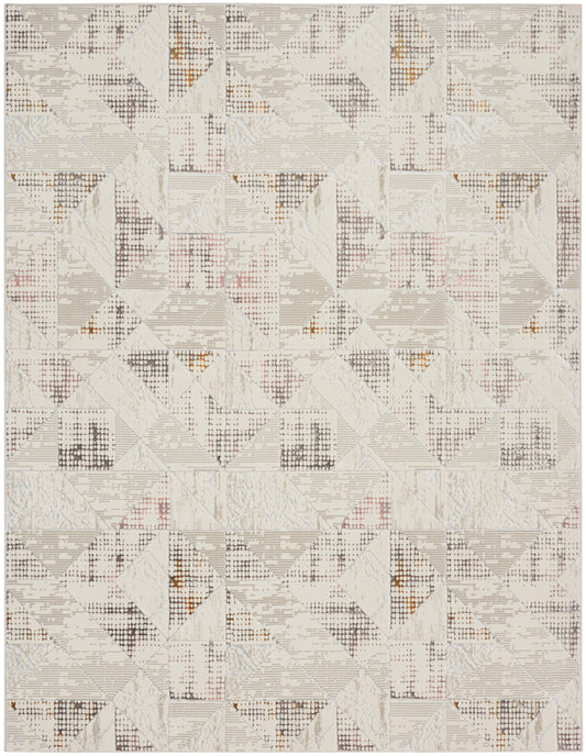 Neutral geometric rug with patchwork triangles in ivory, beige, and light gray, with subtle rust accents.