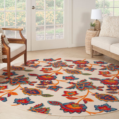 Round floral area rug with ivory backdrop and bright blue, red, orange flowers; woven texture in a bright living room.