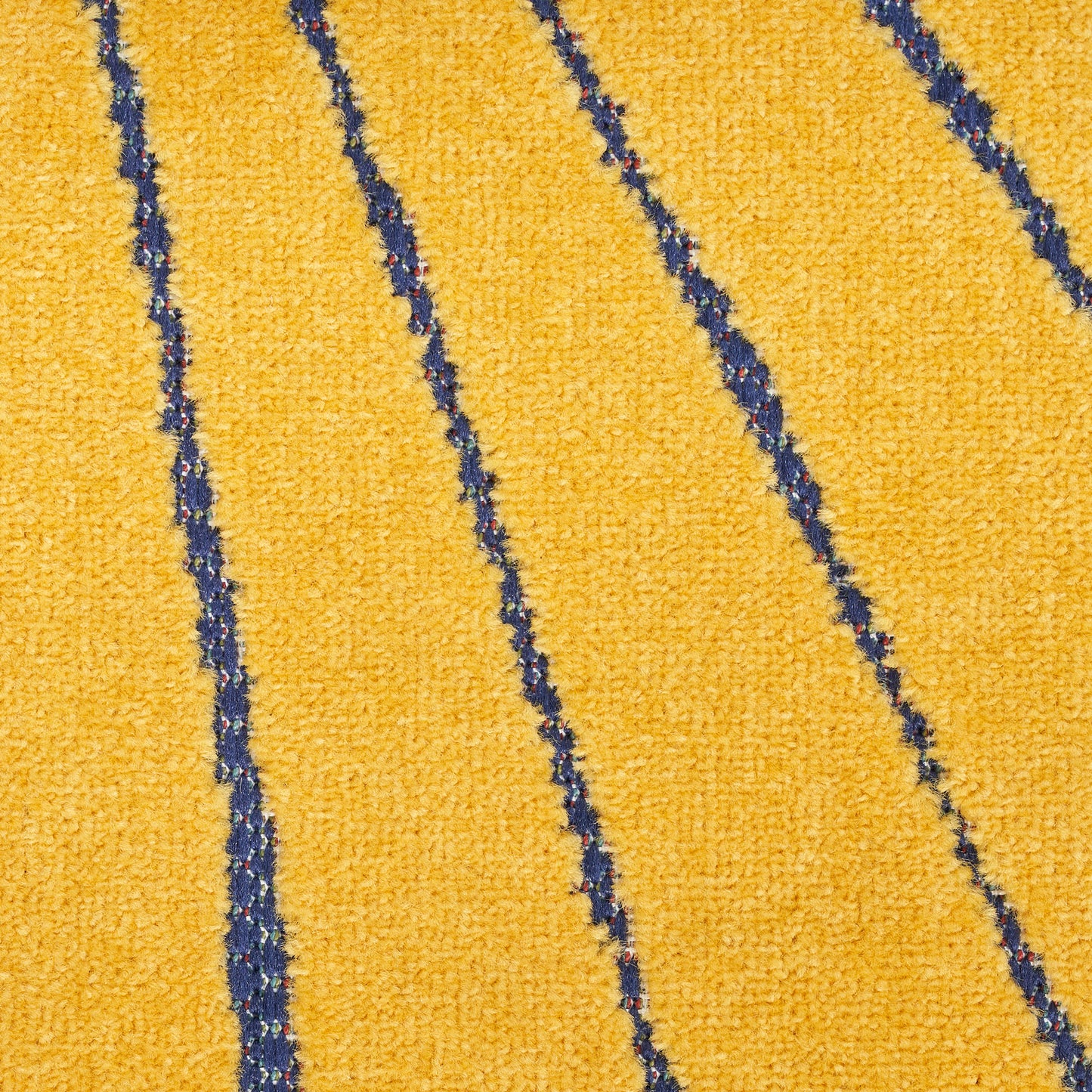 Close-up of a yellow textured rug with dark navy diagonal stripes.