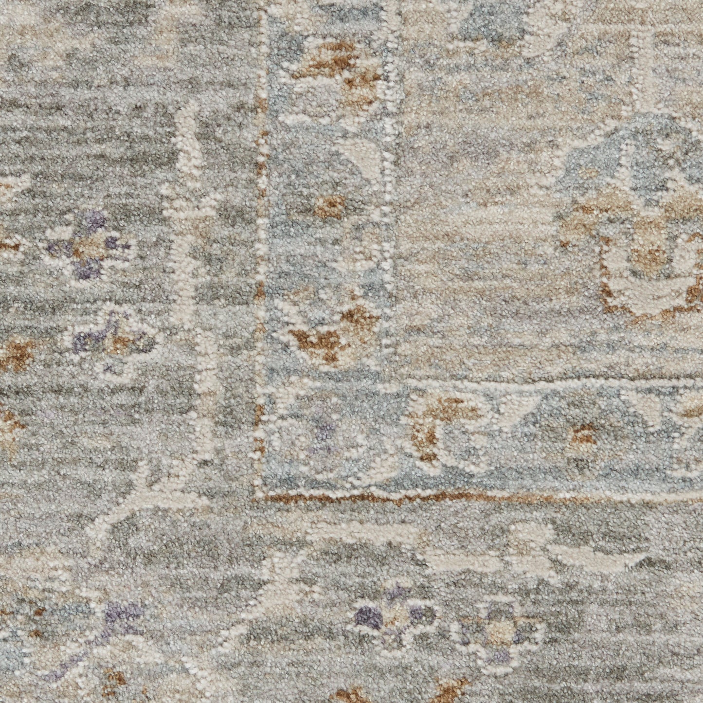 Muted gray-blue oriental rug close-up with ivory borders and soft beige floral accents.