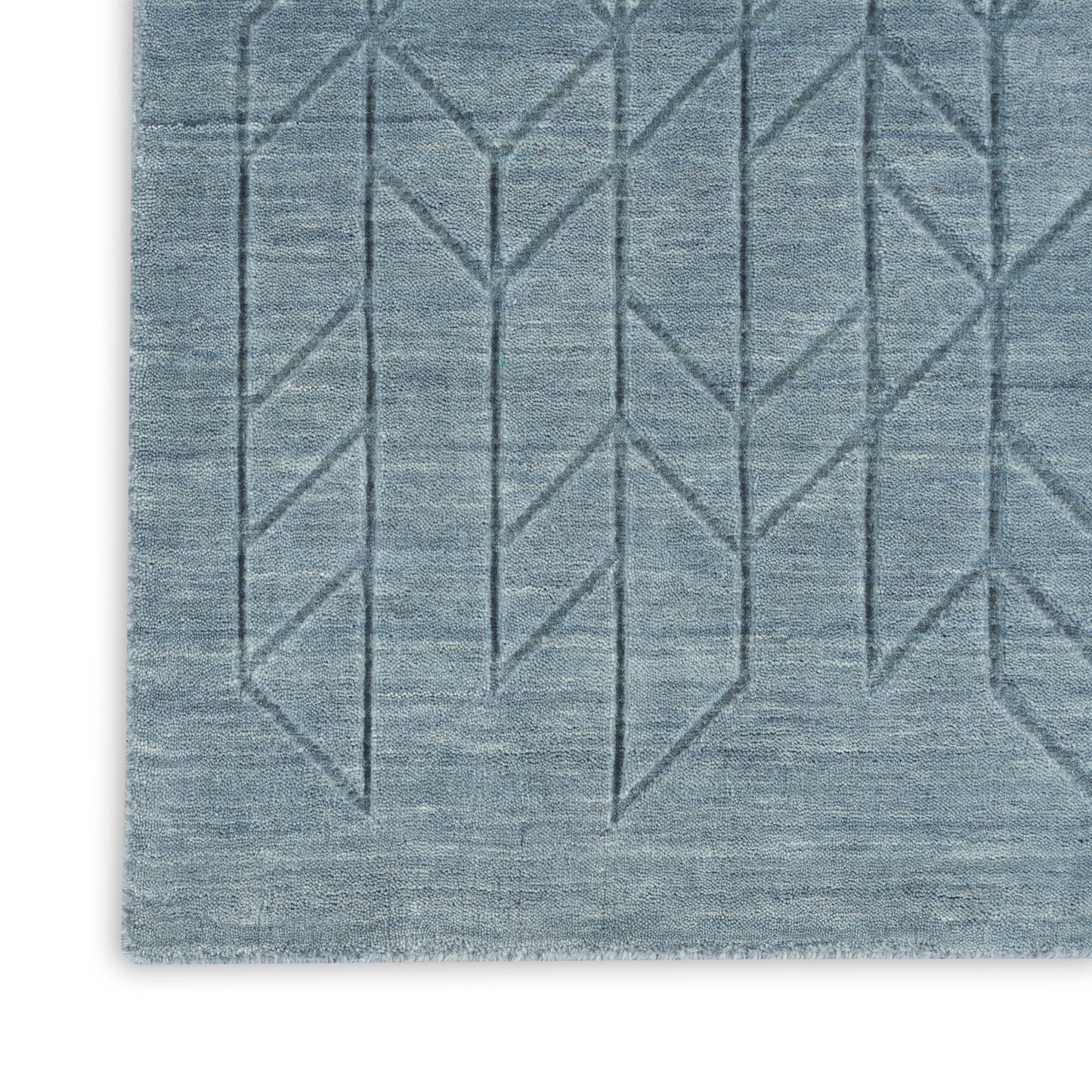 Blue-gray woven rug with subtle geometric diamond chevron lines and textured surface.