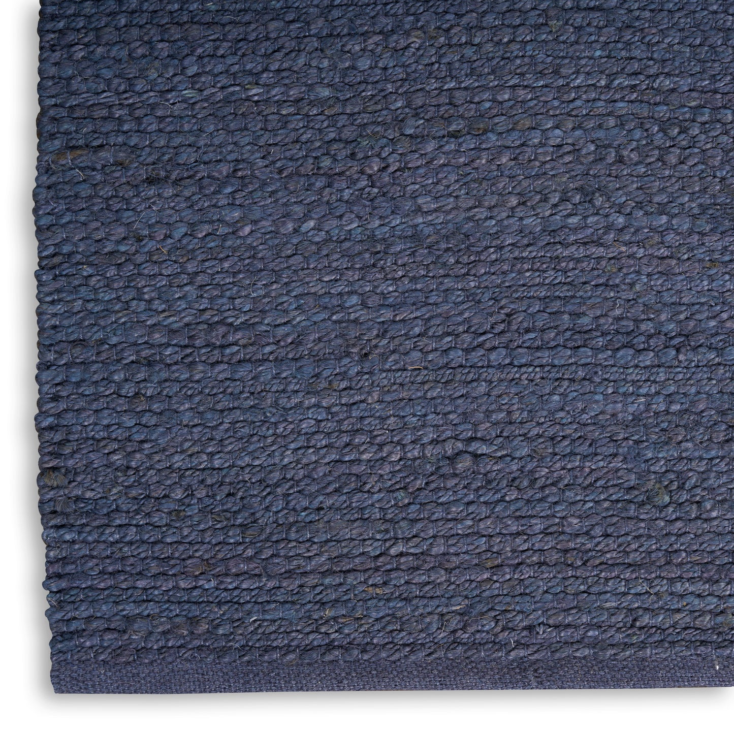 Close-up of navy blue rug with dense loop pile and finished edge.