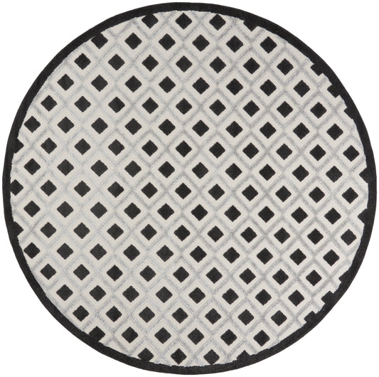 Round rug with light gray field and black diamond lattice pattern, bordered in black.