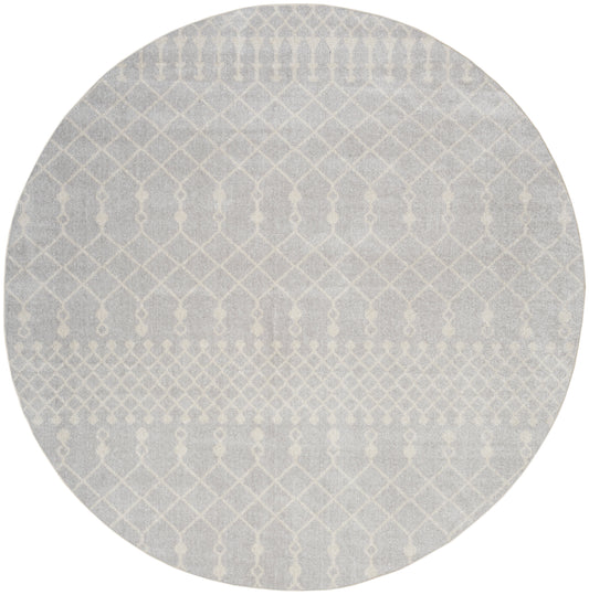 Round gray rug with white geometric lattice pattern; modern, textured, low-pile style.
