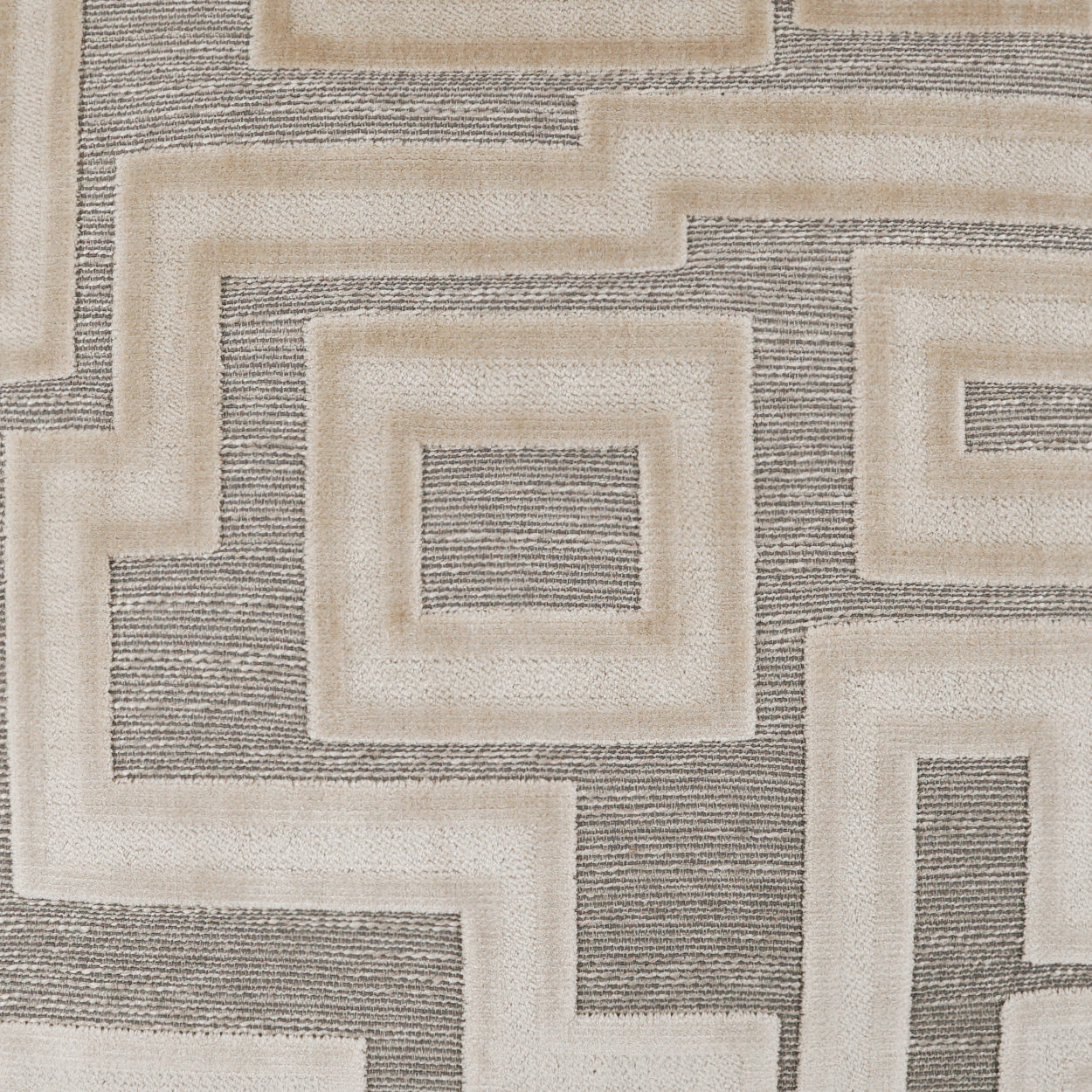 Beige and gray geometric rug with interlocking concentric square motifs; woven textile, modern abstract style.