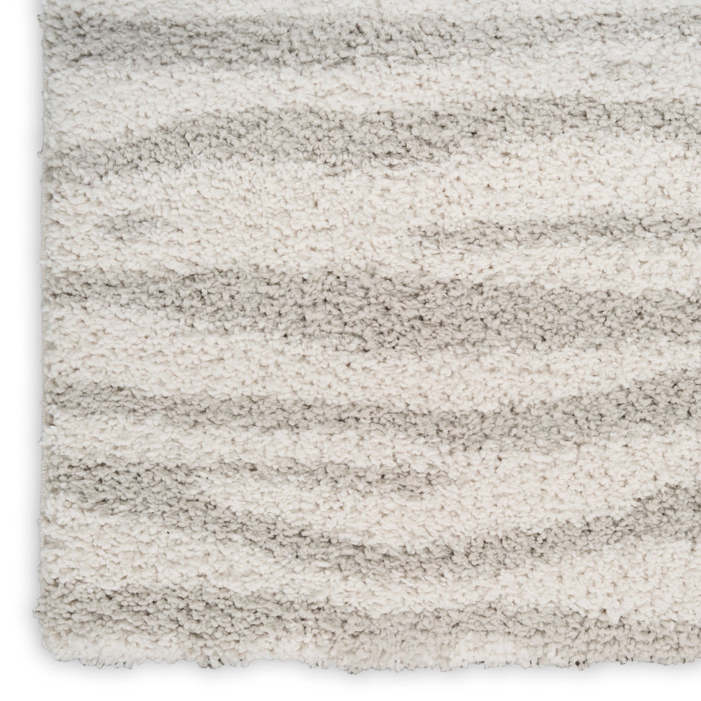Shaggy cream and light gray striped rug with plush textured pile.