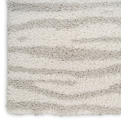 Shaggy cream and light gray striped rug with plush textured pile.