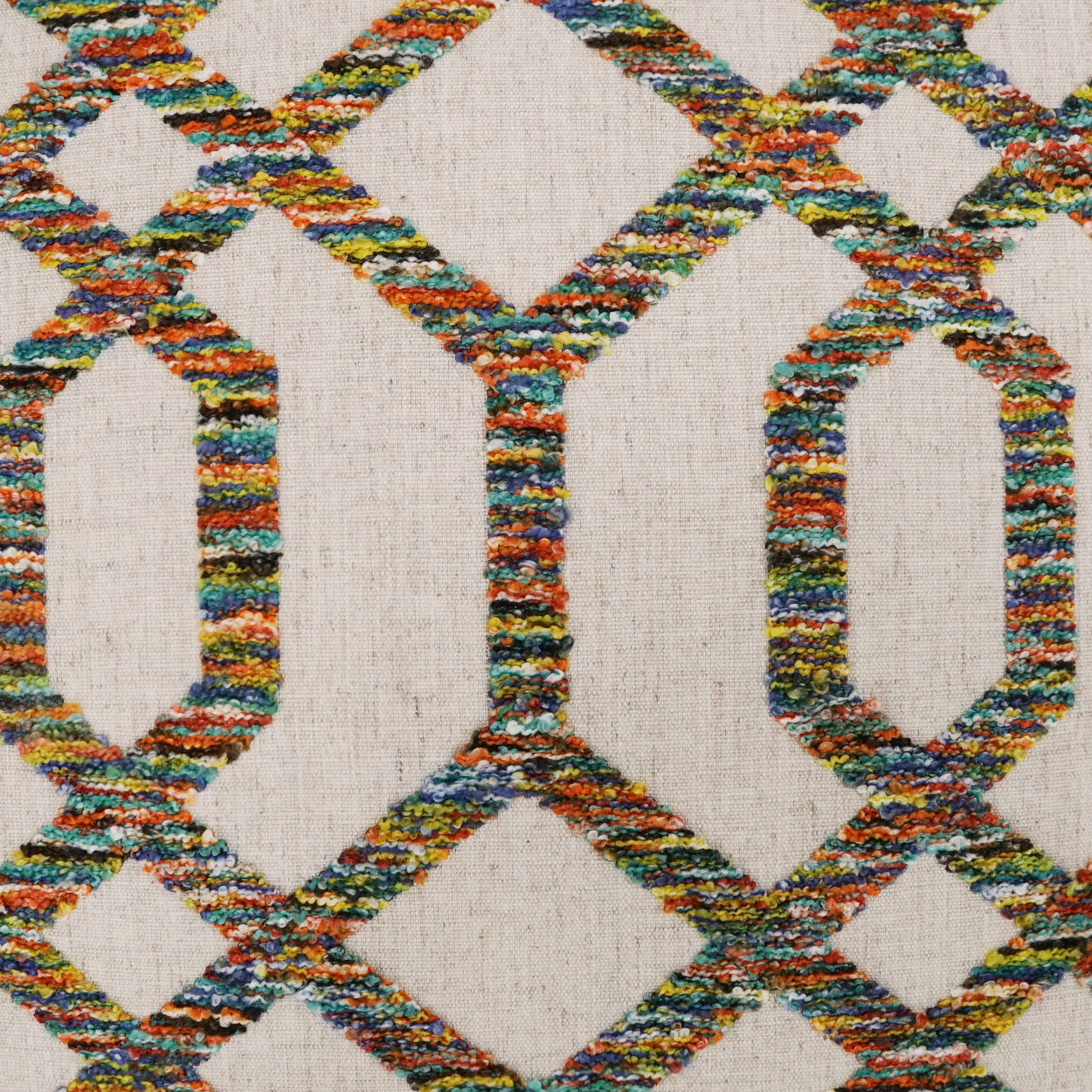Multicolored woven fabric with rope-like lattice diamonds on natural beige background; boho geometric pillow.