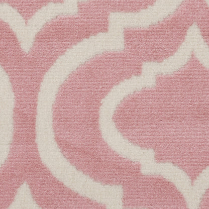Pink rug with white arabesque pattern in a soft woven texture.