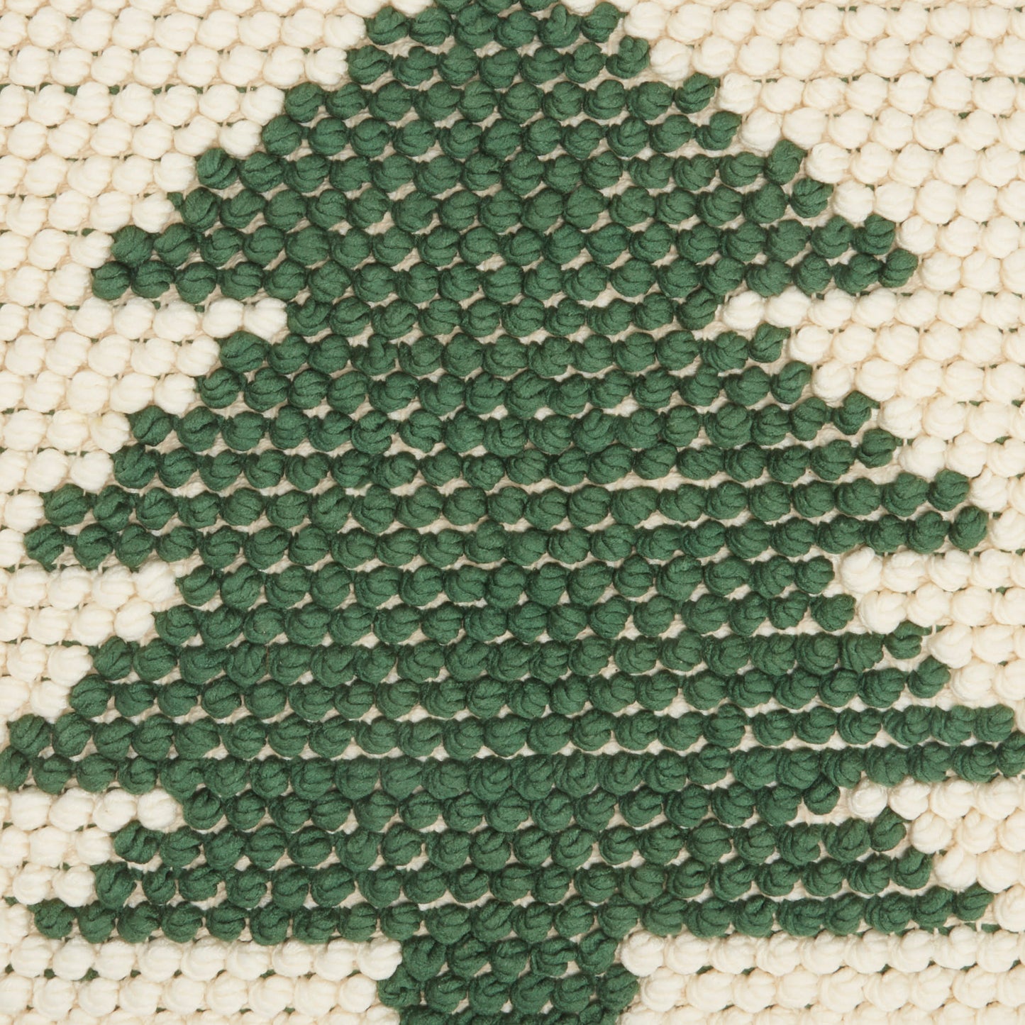 Cream-beige woven rug with a dark green Christmas tree motif.
