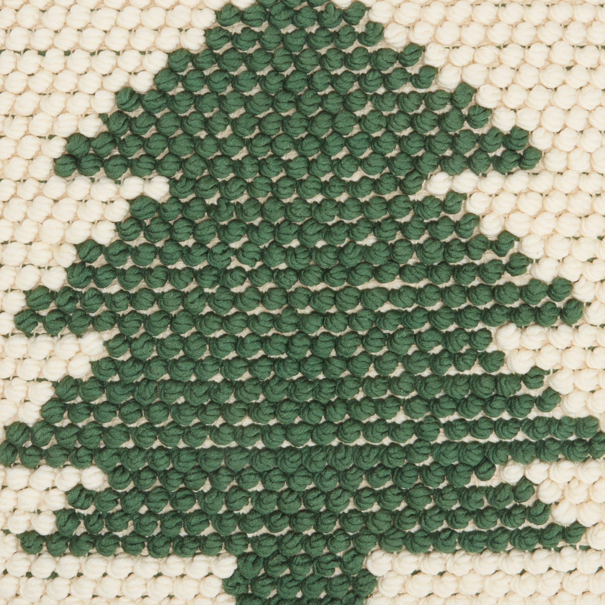 Cream-beige woven rug with a dark green Christmas tree motif.