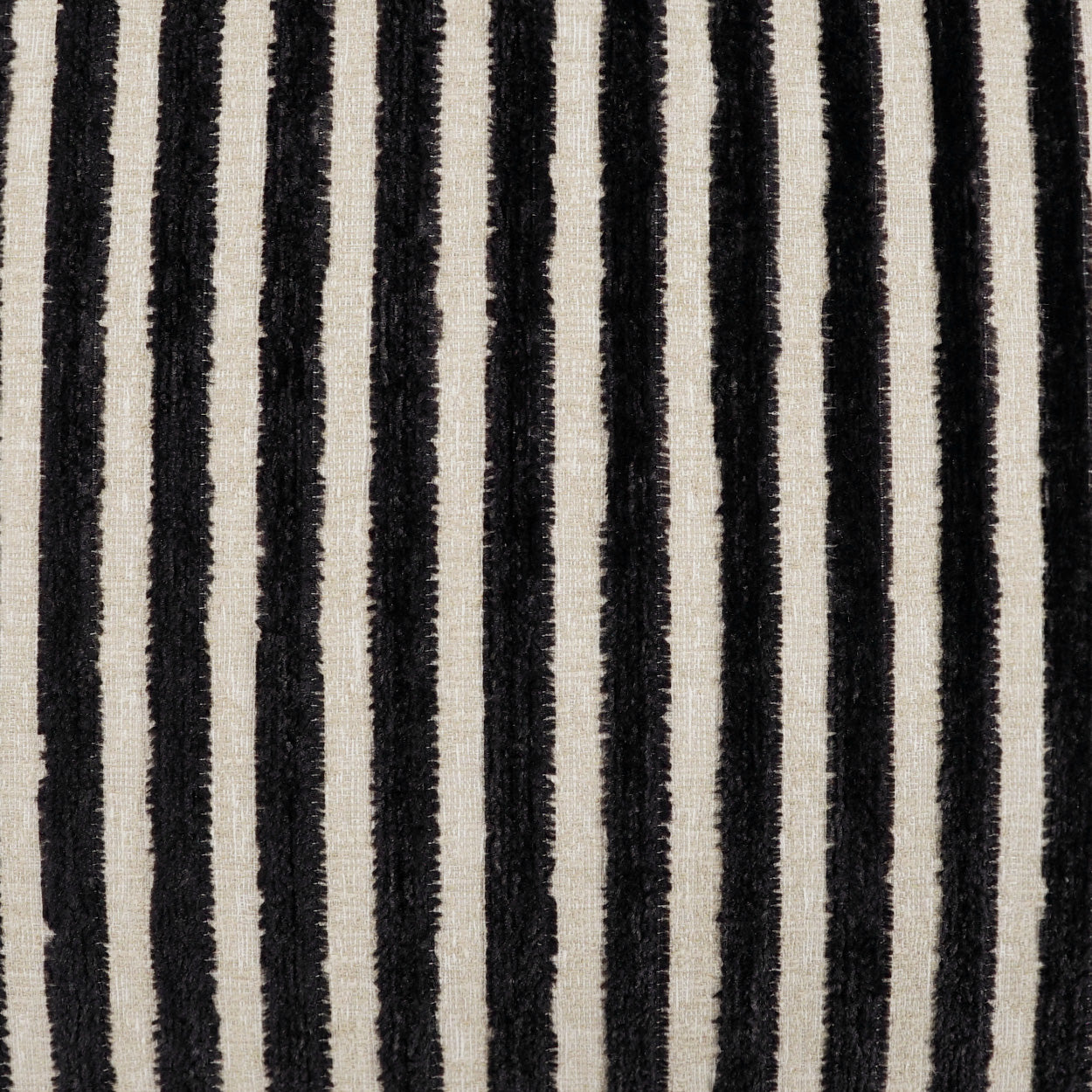 Vertical black and ivory striped rug with a shaggy textured pile, modern floor decor.