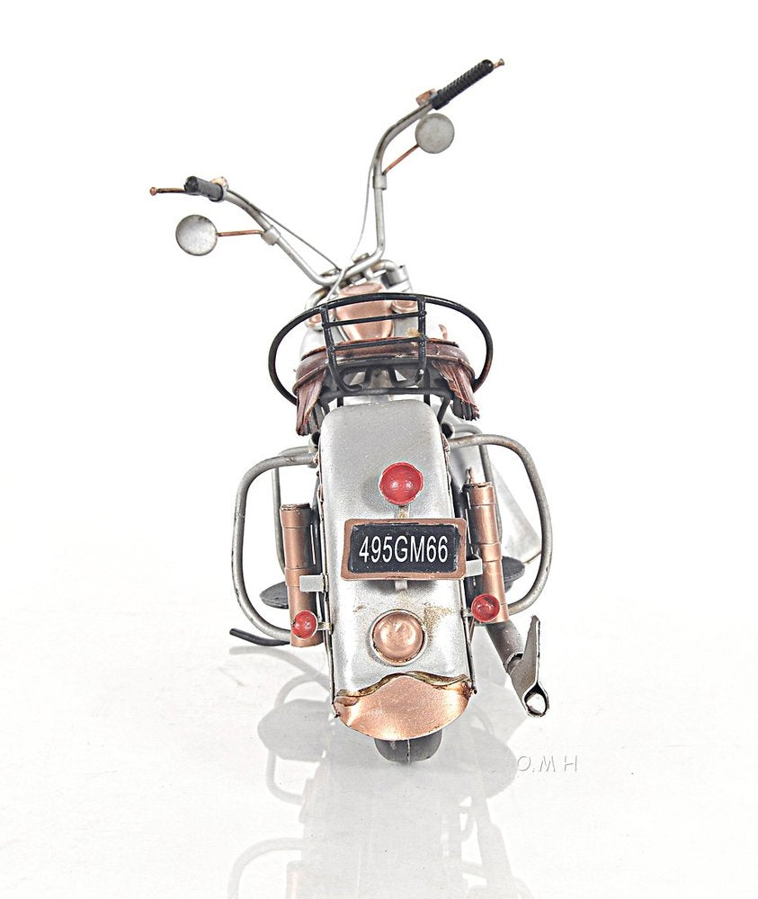 Rear view of vintage silver scooter with tan seat, round mirrors, basket & rack, and license plate.