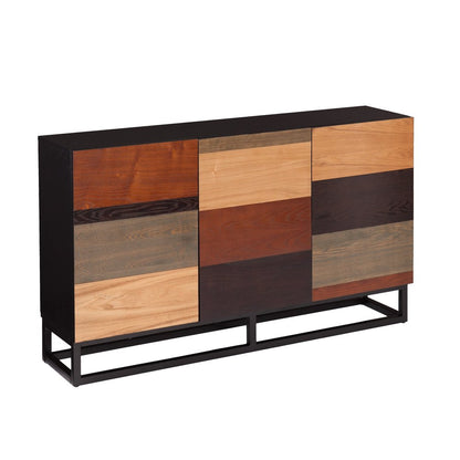 Long modern wooden sideboard cabinet with a black metal base and three patchwork doors in brown, gray and black.