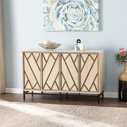 Beige rectangular cabinet with diamond-pattern doors on a black metal base, topped with bowls, against a blue wall.