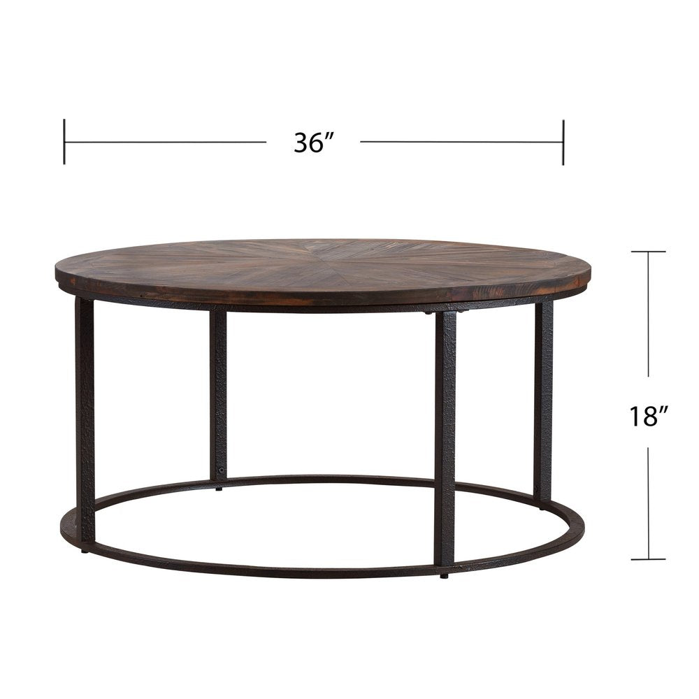 Round coffee table with dark wood top and black metal frame; 36in diameter, 18in tall.