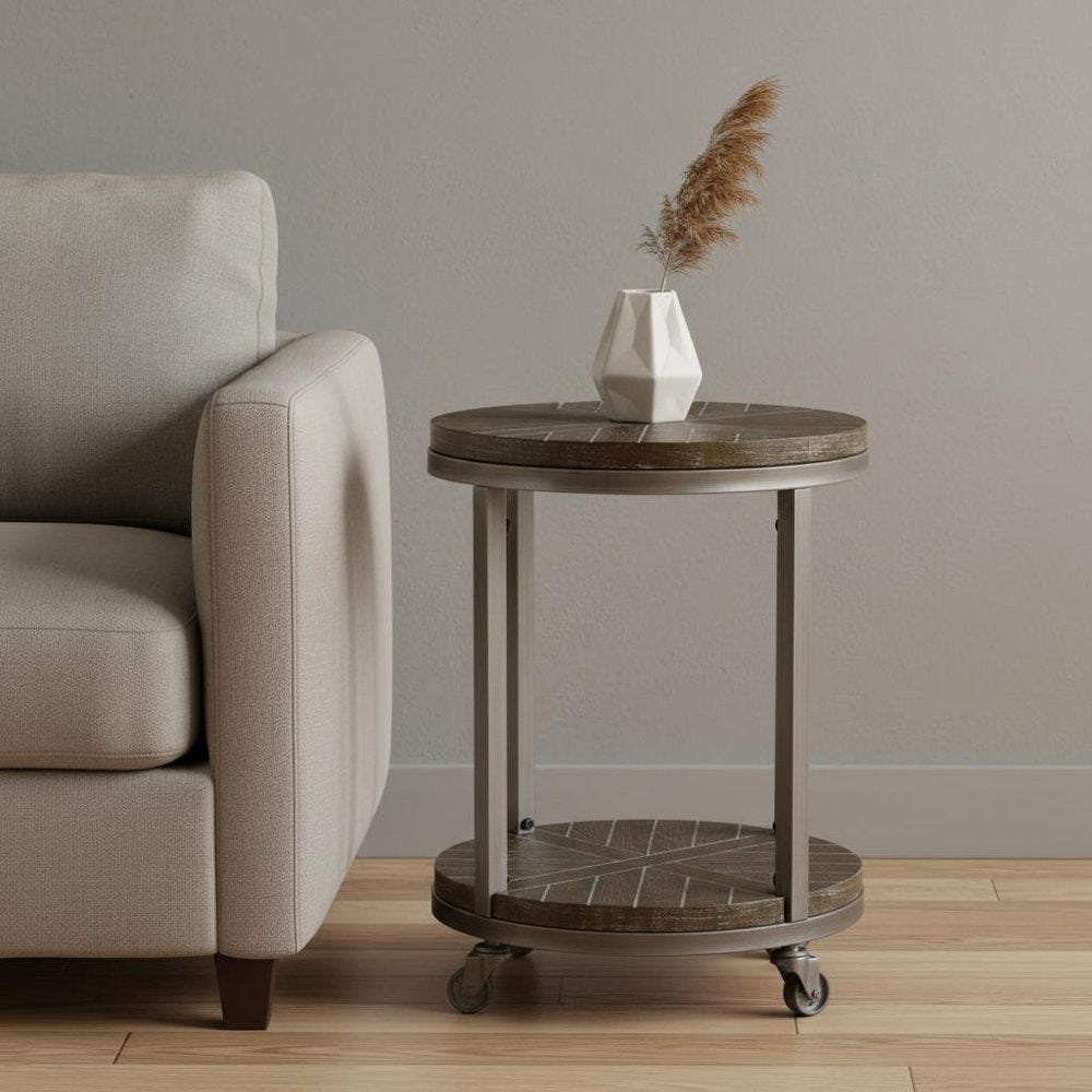 Beige sofa beside a round two-tier rolling side table with a white geometric vase and pampas grass.