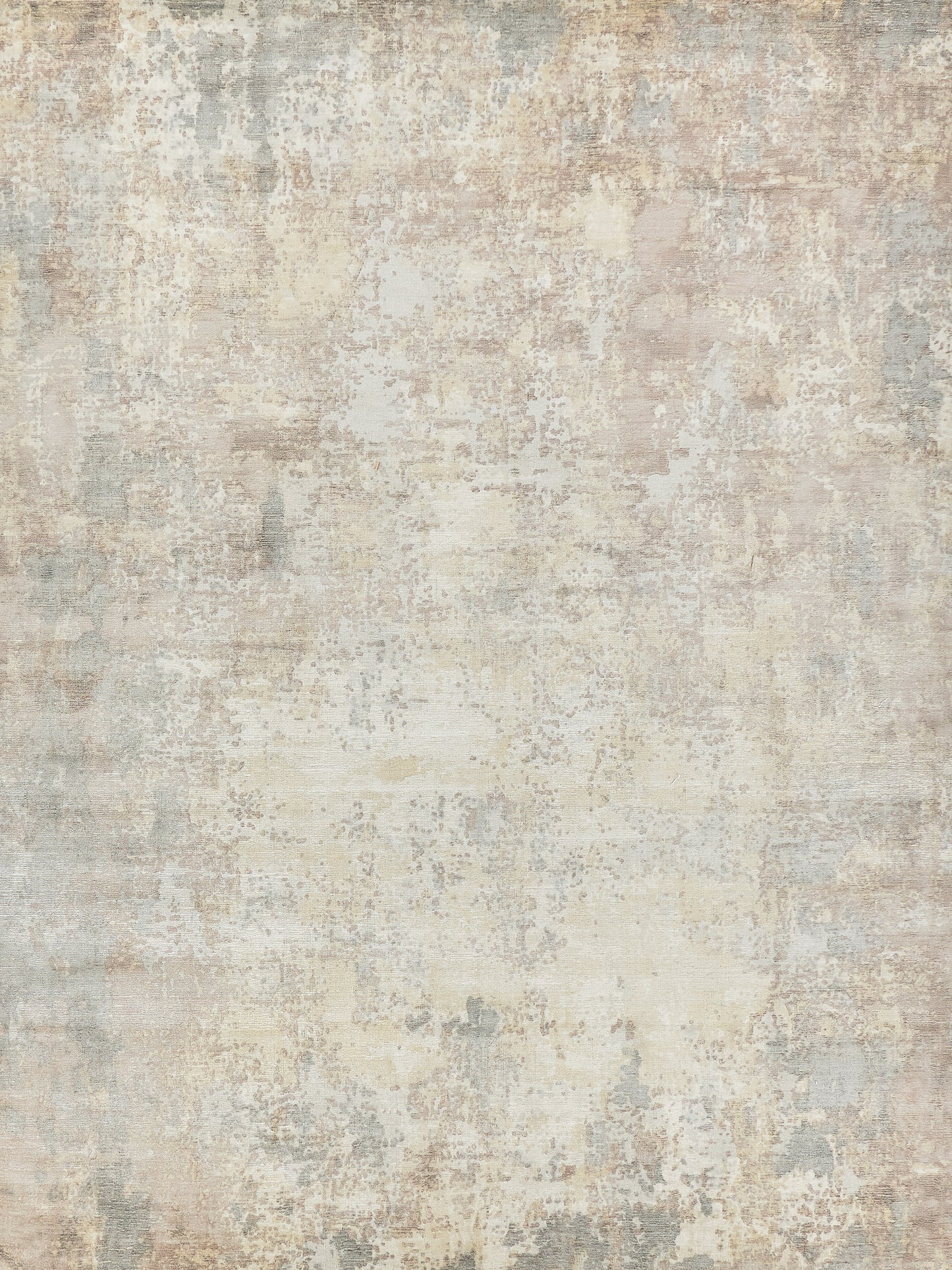 Distressed beige area rug with soft gray, taupe and cream patches in a vintage, abstract pattern.