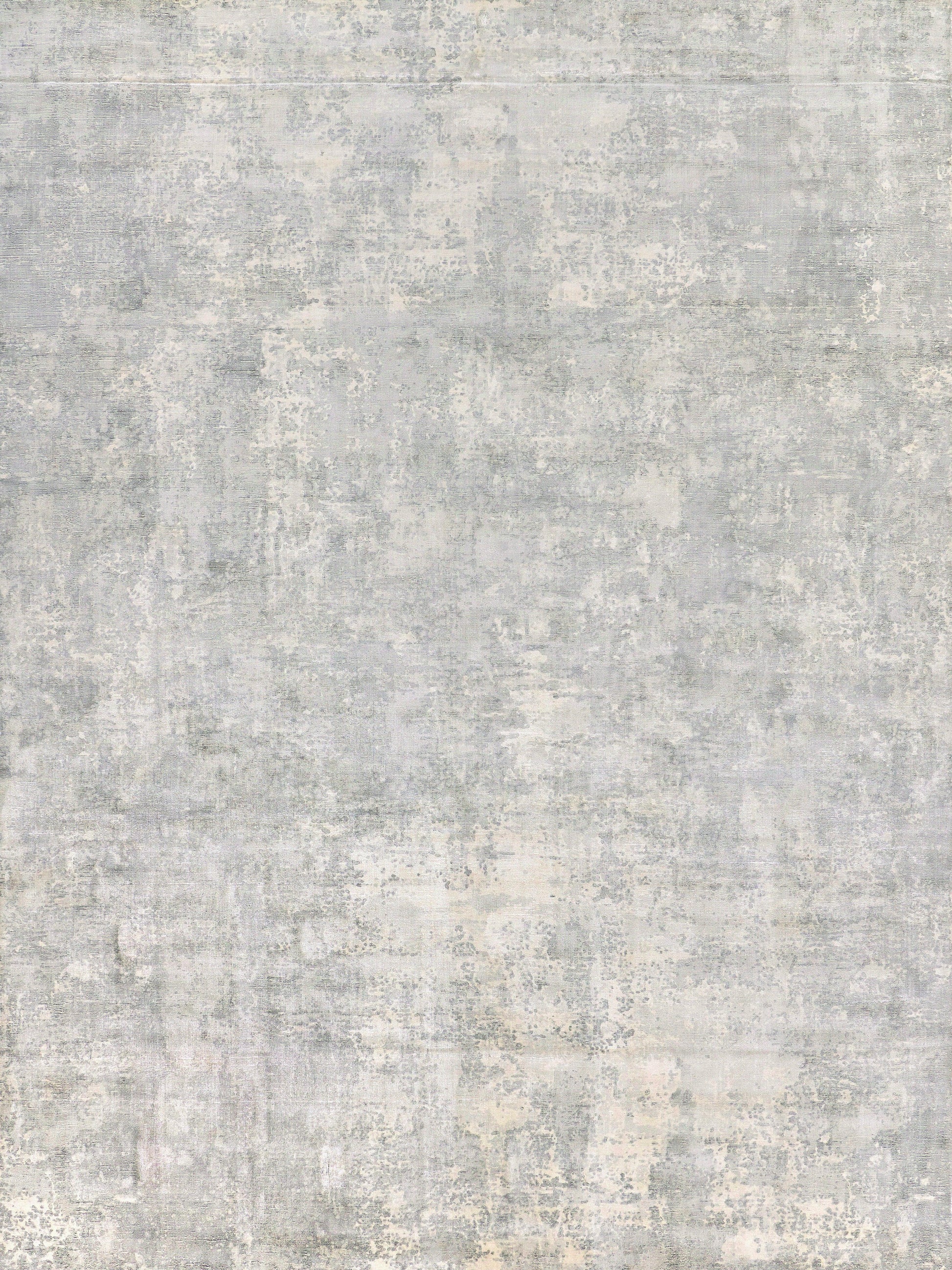 Distressed gray-blue area rug with abstract weathered pattern and soft, muted textures.