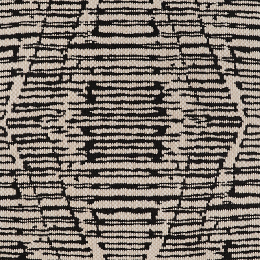 Snake-skin patterned beige and black fabric with a textured woven surface.