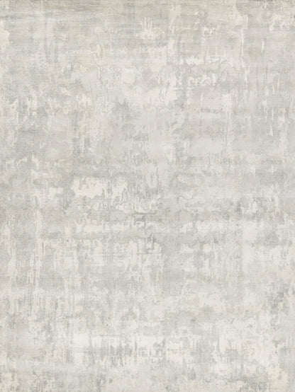 Light gray distressed textured rug with mottled, concrete-like pattern for modern living spaces.