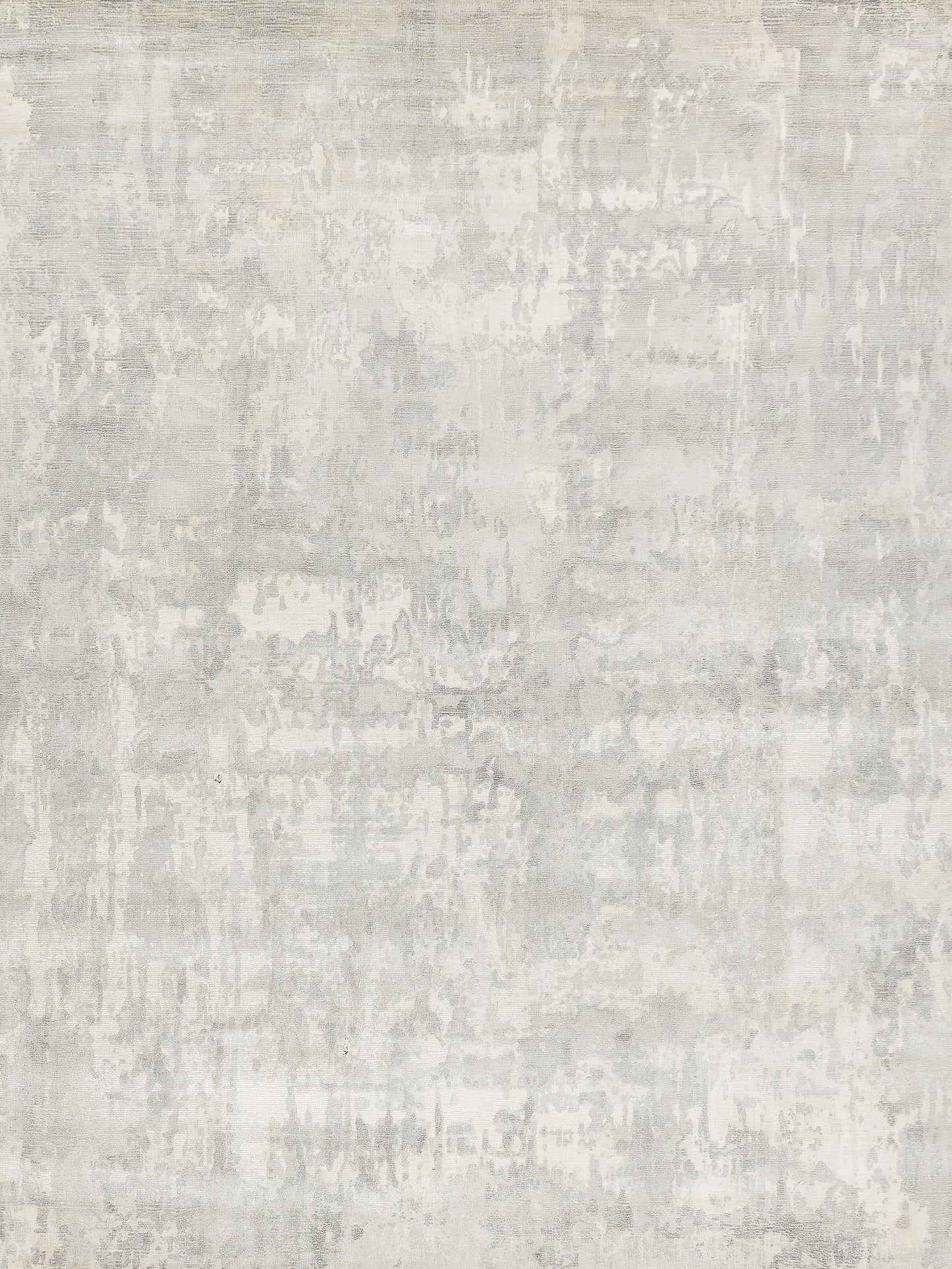 Light gray distressed area rug with concrete-like pattern; modern, neutral decor.