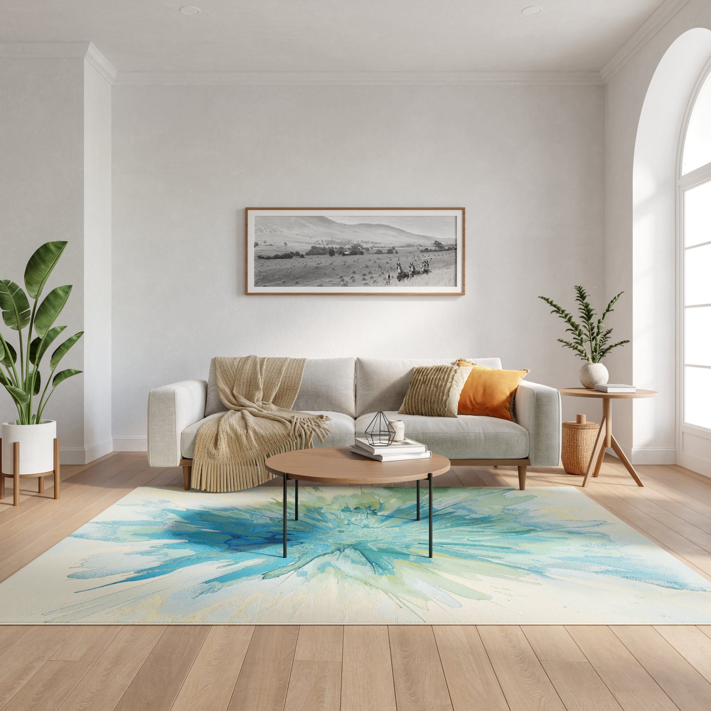 Cozy living room with light gray sofa, beige throw, orange cushion, round wood coffee table, blue watercolor rug, plants.